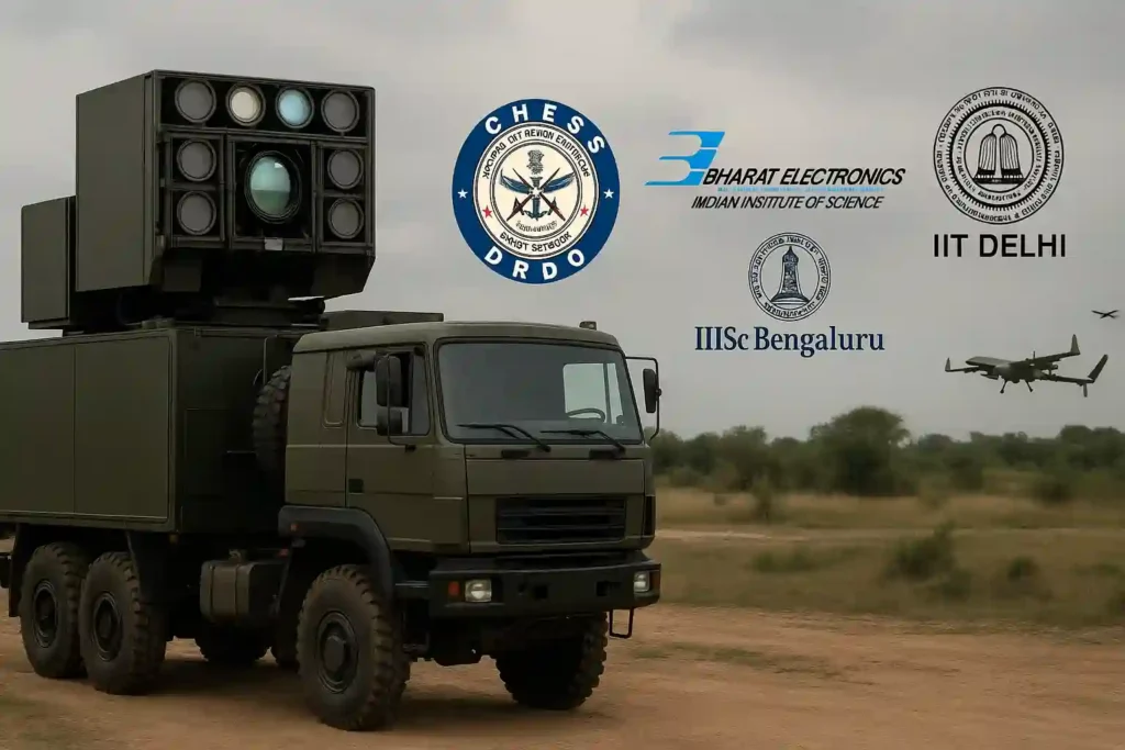 Realistic professional depiction of India's Directed Energy Weapon system mounted on a military truck, highlighting collaboration from CHESS DRDO, Bharat Electronics, IISc Bengaluru, and IIT Delhi with UAVs flying in the background.