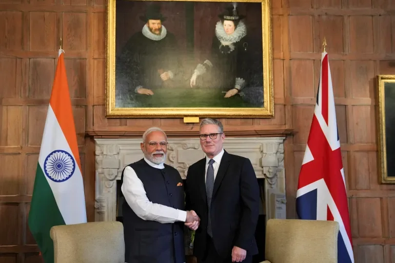 india-uk-free-trade-deal-2025-bilateral-trade-partnership. India and United Kingdom flags with handshake symbolizing India-UK Free Trade Deal 2025 boosting bilateral trade and economic partnership.